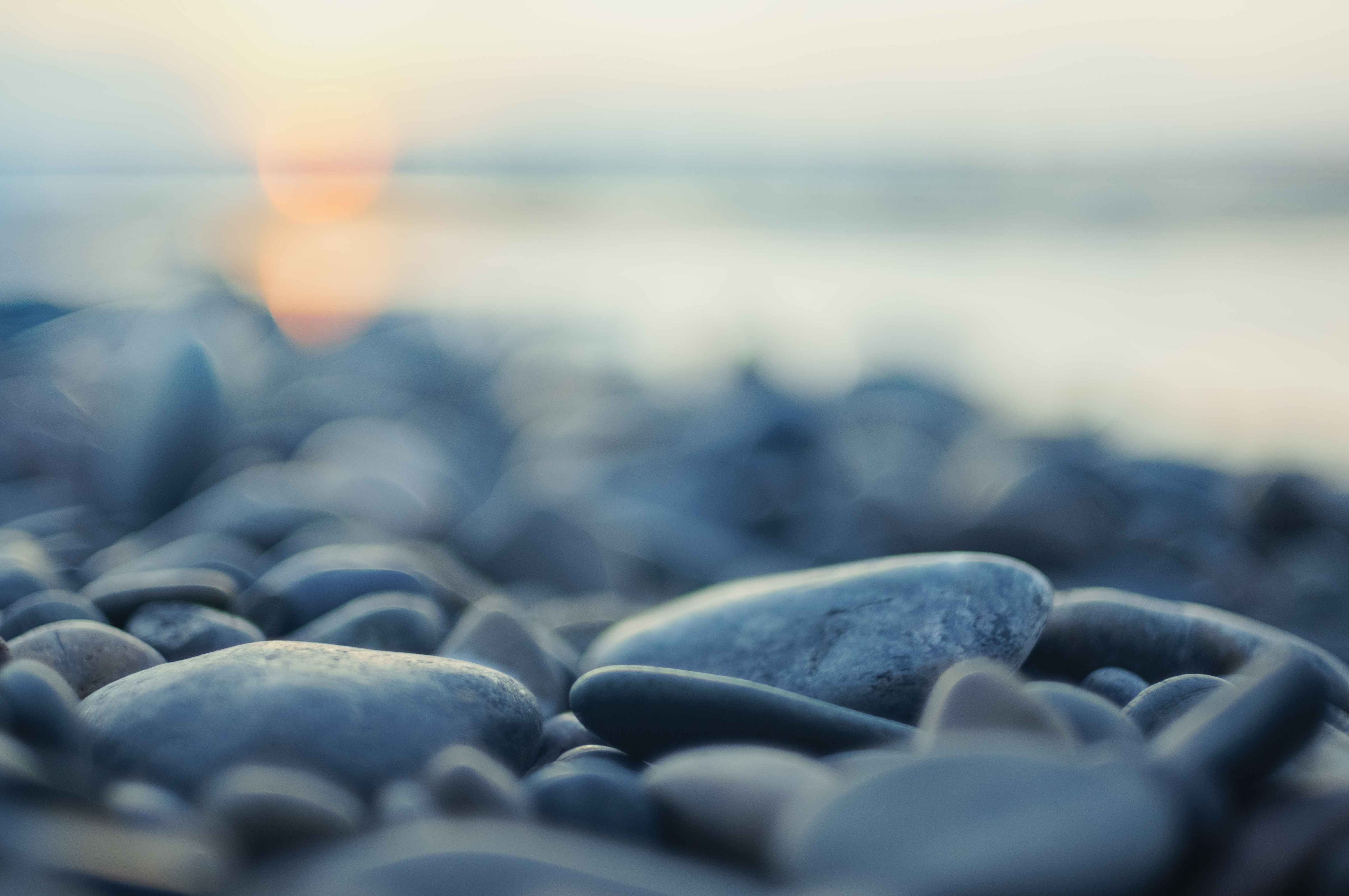 Close up of small rocks along a shore line.